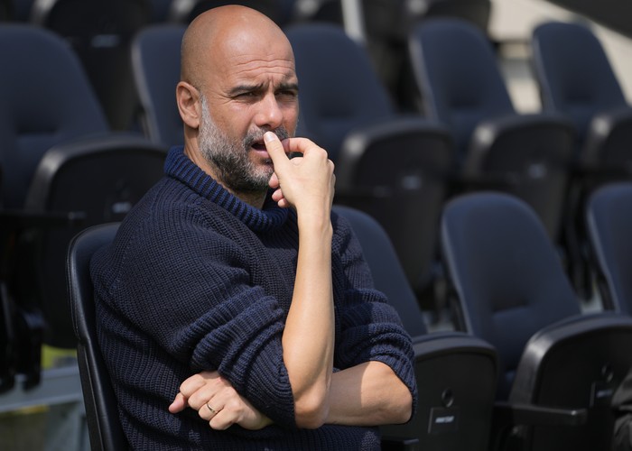 Manchester Citys head coach Pep Guardiola waits for the start of the English Premier League soccer match between Fulham and Manchester City at the Craven Cottage Stadium in London, Saturday, May 11, 2024. (AP Photo/Kirsty Wigglesworth)