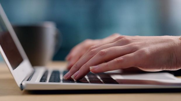 Cropped shot of an unrecognizable businesswoman sitting in her office alone and typing on her laptop