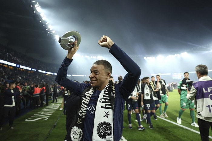 PSGs Kylian Mbappe celebrates PSGs French League One title after the French League One soccer match between Paris Saint-Germain and Toulouse at the Parc des Princes stadium in Paris, Sunday, May 12, 2024. (Franck Fife, Pool via AP)