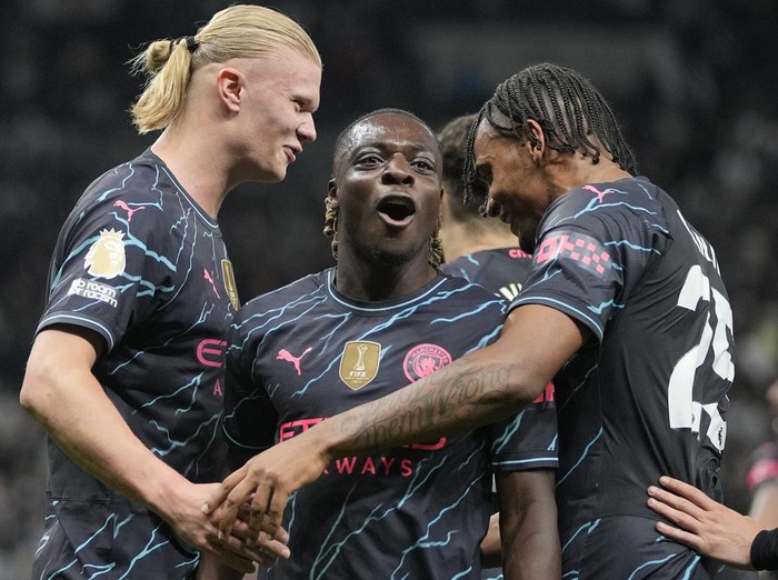 Manchester City's Erling Haaland, from left, Manchester City's Jeremy Doku and Manchester City's Manuel Akanji celebrate scoring their side's second goal during the English Premier League soccer match between Tottenham Hotspur and Manchester City at Tottenham Hotspur Stadium in London, Tuesday, May 14, 2024.(AP Photo/Kin Cheung)
