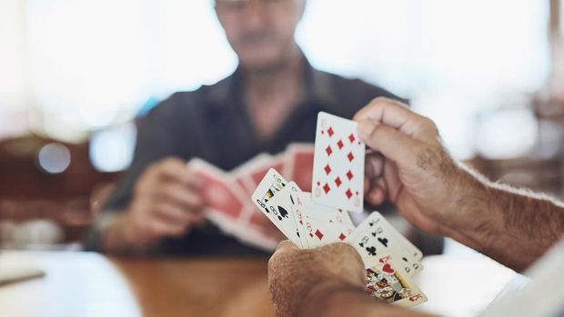 Cropped shot of seniors playing poker in their retirement home