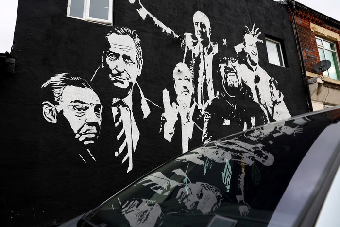 A person takes a picture of a Juergen Klopp mural before his final match as Liverpool manager, Liverpool, Britain, May 16, 2024. REUTERS/Carl Recine
