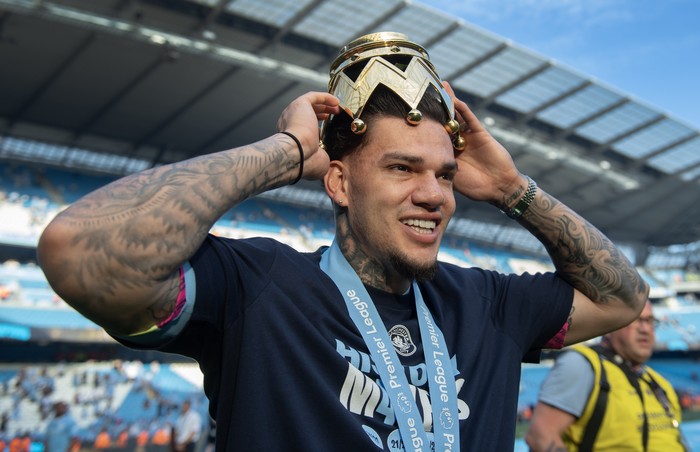 Ederson Moraes MANCHESTER, ENGLAND - MAY 19: Manchester City goalkeeper Ederson with part of the Premier League trophy after the Premier League match between Manchester City and West Ham United at Etihad Stadium on May 19, 2024 in Manchester, England.(Photo by Visionhaus/Getty Images)