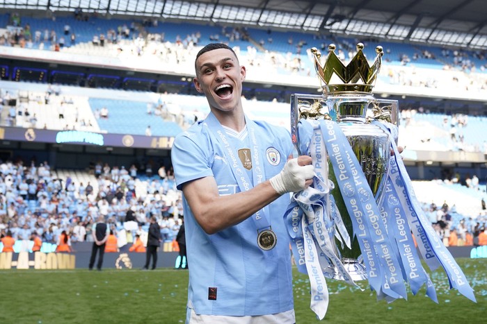 Phil Foden Manchester City's Kyle Walker, center, celebrates with the Premier League trophy with Manchester City's Phil Foden, and Manchester City's Jack Grealish after the English Premier League soccer match between Manchester City and West Ham United at the Etihad Stadium in Manchester, England, Sunday, May 19, 2024. Manchester City clinched the English Premier League on Sunday after beating West Ham in their last match of the season. (AP Photo/Dave Thompson)