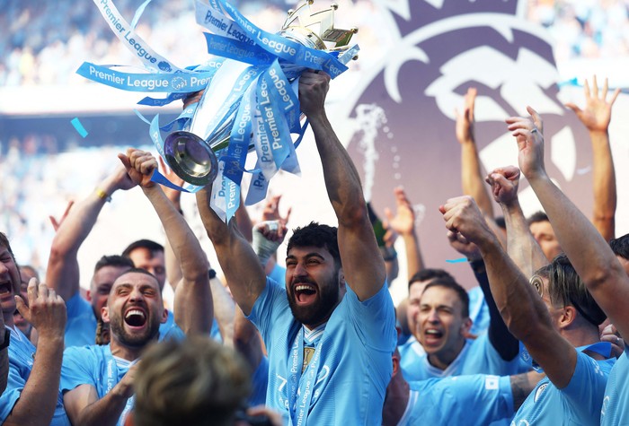 Soccer Football - Premier League - Manchester City v West Ham United - Etihad Stadium, Manchester, Britain - May 19, 2024 
Manchester City's Erling Braut Haaland celebrates with the trophy after winning the Premier League REUTERS/Molly Darlington EDITORIAL USE ONLY. NO USE WITH UNAUTHORIZED AUDIO, VIDEO, DATA, FIXTURE LISTS, CLUB/LEAGUE LOGOS OR 'LIVE' SERVICES. ONLINE IN-MATCH USE LIMITED TO 120 IMAGES, NO VIDEO EMULATION. NO USE IN BETTING, GAMES OR SINGLE CLUB/LEAGUE/PLAYER PUBLICATIONS. PLEASE CONTACT YOUR ACCOUNT REPRESENTATIVE FOR FURTHER DETAILS..