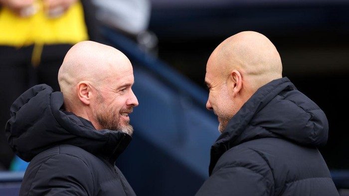 MANCHESTER, ENGLAND - MARCH 03: Erik ten Hag, Manager of Manchester United, and Pep Guardiola, Manager of Manchester City, interact prior to kick-off ahead of the Premier League match between Manchester City and Manchester United at Etihad Stadium on March 03, 2024 in Manchester, England. (Photo by Catherine Ivill/Getty Images)