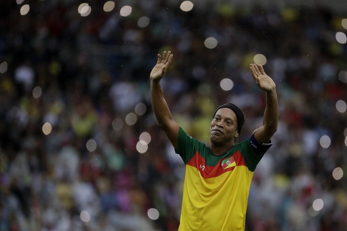 Retired player Ronaldinho Gaucho celebrates scoring a goal in an exhibition soccer match to raise funds for victims of floods affecting southern Brazil, at the Maracana stadium in Rio de Janeiro, Sunday, May 26, 2024. (AP Photo/Bruna Prado)