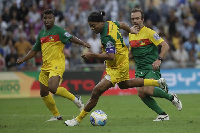 Retired player Ronaldinho Gaucho celebrates scoring a goal in an exhibition soccer match to raise funds for victims of floods affecting southern Brazil, at the Maracana stadium in Rio de Janeiro, Sunday, May 26, 2024. (AP Photo/Bruna Prado)