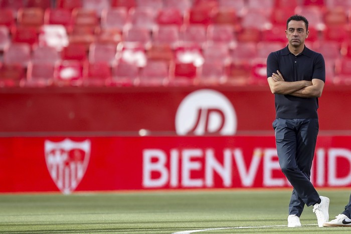 Barcelonas head coach Xavi Hernandez stands ahead the Spanish La Liga soccer match between Sevilla and FC Barcelona at the Ramon Sanchez Pizjuan stadium in Seville, Spain, Sunday, May 26, 2024. (AP Photo/Fermin Rodriguez)