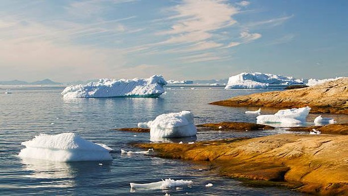 climate change Icebergs from the Jacobshavn glacier or Sermeq Kujalleq drains 7% of the Greenland ice sheet and is the largest glacier outside of Antarctica. It calves enough ice in one day to supply New York with water for one year. It is one of the fastest moving glaciers in the world at up to 40 metres per day (19 metres per day before 2002) and has also receeded rapidly (40 km since 1850) due to human induced climate change as temperatures have risen in Greenland by 9 degrees fahrenheit in the last 60 years. An underwater moraine at the mouth of the fjord grounds the largest icebergs causing a backlog of ice completely blocking the entire length of the fjord with ice.