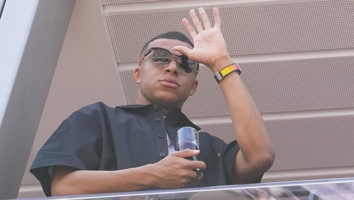 Kylian Mbappe waves from a terrace before the Formula One Monaco Grand Prix race at the Monaco racetrack, in Monaco, Sunday, May 26, 2024. (AP Photo/Luca Bruno)