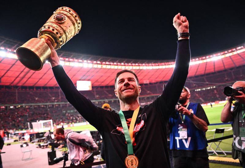 Soccer Football - DFB Cup - Final - 1.FC Kaiserslautern v Bayer Leverkusen - Olympiastadion, Berlin, Germany - May 25, 2024 Bayer Leverkusen coach Xabi Alonso celebrates with the trophy after winning the DFB Cup REUTERS/Annegret Hilse DFB REGULATIONS PROHIBIT ANY USE OF PHOTOGRAPHS AS IMAGE SEQUENCES AND/OR QUASI-VIDEO.