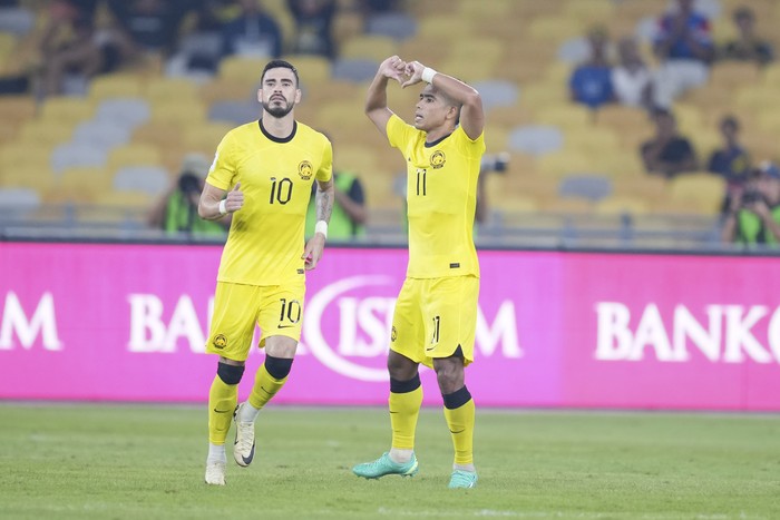 Malaysias Safawi Rasid, left, reacts after scoring the first goal during a 2026 FIFA World Cup qualifying soccer group D match between Malaysia and Taiwan in Bukit Jalil Stadium in Kuala Lumpur, Malaysia, Tuesday, June 11, 2024. (AP Photo/Vincent Thian)