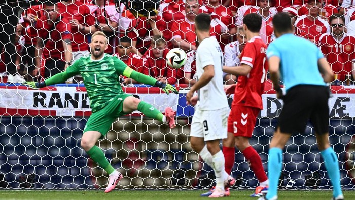16 June 2024, Baden-Württemberg, Stuttgart: Soccer: European Championship, Slovenia - Denmark, preliminary round, group C, match day 1, Stuttgart Arena, Denmarks goalkeeper Kasper Schmeichel (l) cant avoid the goal by Slovenias Janza (not in the picture). Photo: Tom Weller/dpa (Photo by Tom Weller/picture alliance via Getty Images)