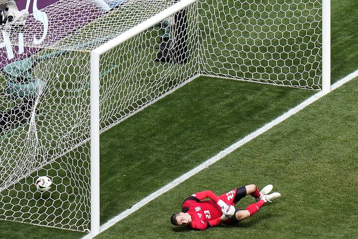 Ukraines goalkeeper Andriy Lunin tries to save the ball as the Romanias Nicolae Stanciu scores the opening goal against Ukraine during a Group E match between Romania and Ukraine at the Euro 2024 soccer tournament in Munich, Germany, Monday, June 17, 2024. (AP Photo/Ariel Schalit)