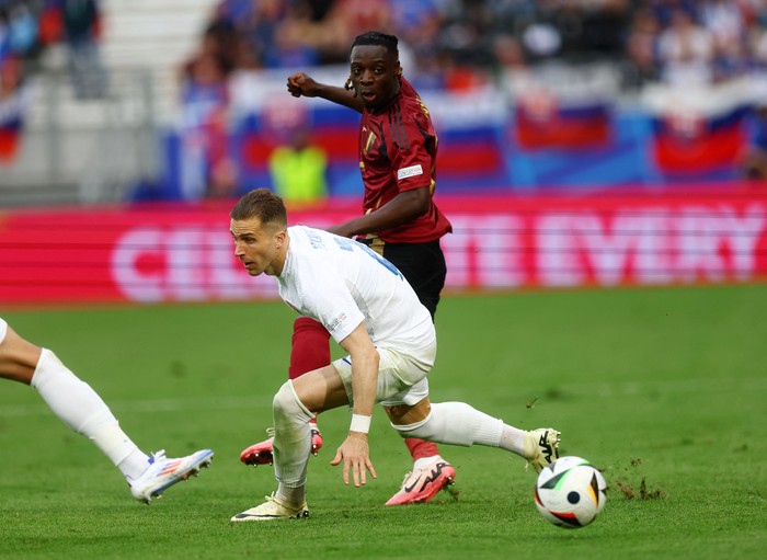 Soccer Football - Euro 2024 - Group E - Belgium v Slovakia - Frankfurt Arena, Frankfurt, Germany - June 17, 2024 Slovakias Peter Pekarik in action with Belgiums Jeremy Doku REUTERS/Lee Smith
