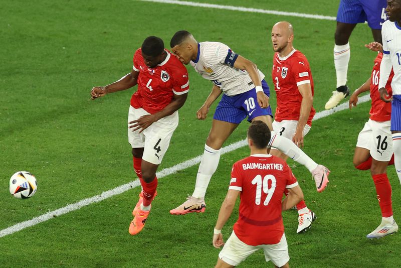 DUSSELDORF, GERMANY - JUNE 17: (EDITORS NOTE: Image contains graphic content.) Kylian Mbappe of France clashes heads with Kevin Danso of Austria during the UEFA EURO 2024 group stage match between Austria and France at Düsseldorf Arena on June 17, 2024 in Dusseldorf, Germany. (Photo by Lars Baron/Getty Images)