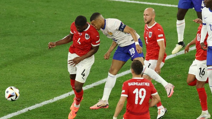Kylian Mbappe DUSSELDORF, GERMANY - JUNE 17: (EDITORS NOTE: Image contains graphic content.) Kylian Mbappe of France clashes heads with Kevin Danso of Austria during the UEFA EURO 2024 group stage match between Austria and France at Düsseldorf Arena on June 17, 2024 in Dusseldorf, Germany. (Photo by Lars Baron/Getty Images)