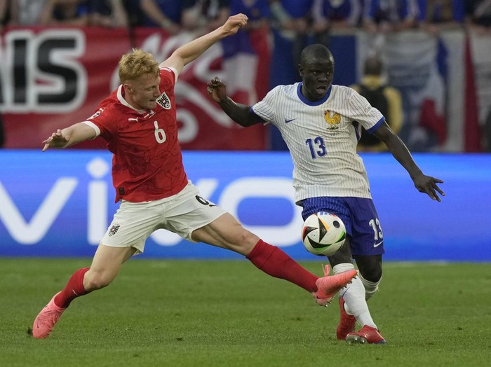 Austria's Nicolas Seiwald, left, challenges for the ball with N'Golo Kante of France during a Group D match between Austria and France at the Euro 2024 soccer tournament in Duesseldorf, Germany, Monday, June 17, 2024. (AP Photo/Frank Augstein)