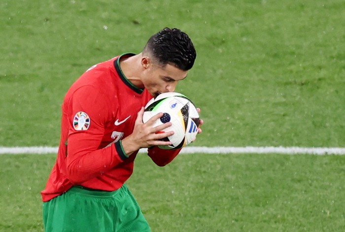 Soccer Football - Euro 2024 - Group F - Portugal v Czech Republic - Leipzig Stadium, Leipzig, Germany - June 18, 2024  Portugals Cristiano Ronaldo kisses the ball REUTERS/Karina Hessland