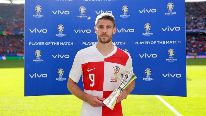 HAMBURG, GERMANY - JUNE 19: Andrej Kramaric of Croatia poses for a photo with the Vivo Player of the Match award after the draw in the UEFA EURO 2024 group stage match between Croatia and Albania at Volksparkstadion on June 19, 2024 in Hamburg, Germany. (Photo by Joosep Martinson - UEFA/UEFA via Getty Images)