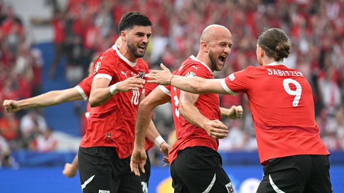 BERLIN, GERMANY - JUNE 21: Gernot Trauner of Austria celebrates scoring his teams first goal with teammate Marcel Sabitzer during the UEFA EURO 2024 group stage match between Poland and Austria at Olympiastadion on June 21, 2024 in Berlin, Germany. (Photo by Stuart Franklin - UEFA/UEFA via Getty Images)