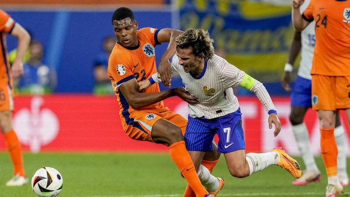 Denzel Dumfries of the Netherlands, left, and Antoine Griezmann of France challenge for the ball during a Group D match between the Netherlands and France at the Euro 2024 soccer tournament in Leipzig, Germany, Friday, June 21, 2024. (AP Photo/Antonio Calanni)