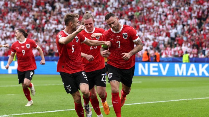 BERLIN, GERMANY - JUNE 21: Marko Arnautovic of Austria celebrates scoring his teams third goal from a penalty kick with teammates during the UEFA EURO 2024 group stage match between Poland and Austria at Olympiastadion on June 21, 2024 in Berlin, Germany. (Photo by Alex Livesey/Getty Images)