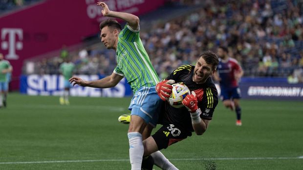 Jun 22, 2024; Seattle, Washington, USA; Seattle Sounders FC forward Daniel Musovski (17) and FC Dallas goalkeeper Maarten Paes (30) collide during the second half at Lumen Field. Mandatory Credit: Stephen Brashear-USA TODAY Sports