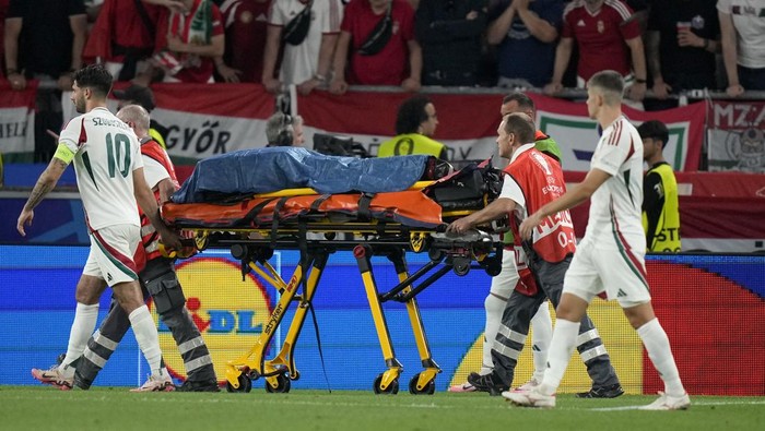 Hungary's Barnabas Varga is strechered out after being injured during a Group A match between Scotland and Hungary at the Euro 2024 soccer tournament in Stuttgart, Germany, Sunday, June 23, 2024. (AP Photo/Matthias Schrader)