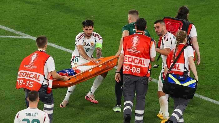 STUTTGART, GERMANY - JUNE 23: Dominik Szoboszlai of Hungary argues with medical support staff as he attempts to pull the stretcher towards teammate Barnabas Varga during the UEFA EURO 2024 group stage match between Scotland and Hungary at Stuttgart Arena on June 23, 2024 in Stuttgart, Germany. (Photo by James Gill - Danehouse/Getty Images)