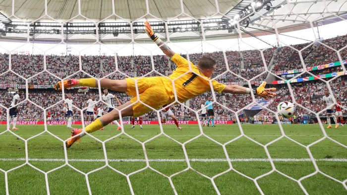 FRANKFURT AM MAIN, GERMANY - JUNE 20: (EDITORS NOTE: Image was captured using a static remote camera behind the goal.) A general view as Jordan Pickford of England fails to make a save as Morten Hjulmand of Denmark scores his teams first goal during the UEFA EURO 2024 group stage match between Denmark and England at Frankfurt Arena on June 20, 2024 in Frankfurt am Main, Germany. (Photo by Alex Grimm/Getty Images)