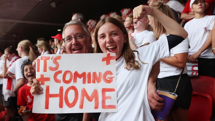 LONDON, ENGLAND - JULY 31: England fans celebrate with a sign that reads Its Coming Home following victory during the UEFA Womens Euro 2022 final match between England and Germany at Wembley Stadium on July 31, 2022 in London, England. (Photo by Julian Finney - The FA/The FA via Getty Images)