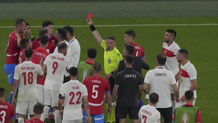 Referee Istvan Kovacs shows the red card to Czech Republics Tomas Chory during a Group F match between Czech Republic and Turkey at the Euro 2024 soccer tournament in Hamburg, Germany, Wednesday, June 26, 2024. (AP Photo/Sunday Alamba)