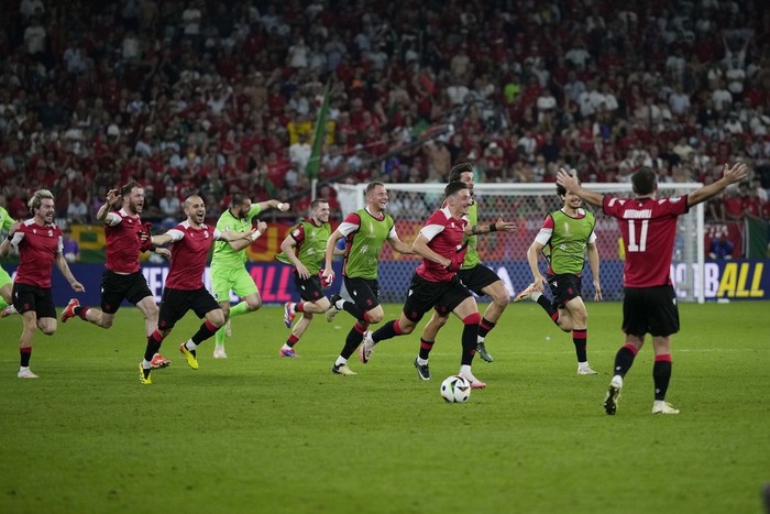 Georgias Georges Mikautadze celebrates after scoring on a penalty kick during a Group F match between Georgia and Portugal at the Euro 2024 soccer tournament in Gelsenkirchen, Germany, Wednesday, June 26, 2024. (AP Photo/Martin Meissner)