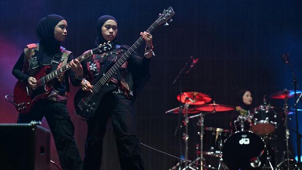 Firda Marsya Kurnia (L) and Widi Rahmawati of Indonesian rock band Voice of Baceprot, perform on the Woodsies stage on the third day of the Glastonbury festival at Worthy Farm in the village of Pilton in Somerset, southwest England, on June 28, 2024. The festival takes place from June 26 to June 30. (Photo by Oli SCARFF / AFP)