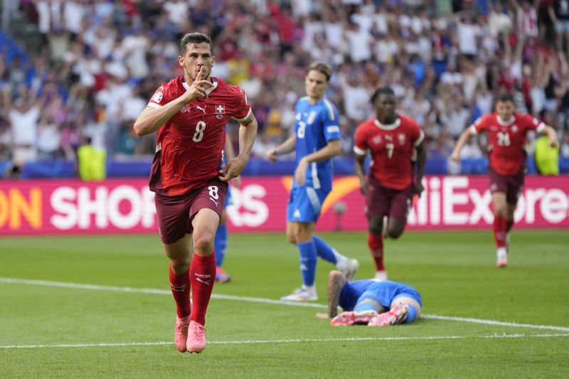 Switzerland's Remo Freuler (8) celebrates after scoring during a round of sixteen match between Switzerland and Italy at the Euro 2024 soccer tournament in Berlin, Germany, Saturday, June 29, 2024. (AP Photo/Matthias Schrader)