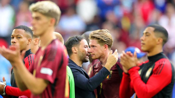 01 July 2024, North Rhine-Westphalia, Duesseldorf: Soccer, UEFA Euro 2024, European Championship, France - Belgium, final round, round of 16, Düsseldorf Arena, Belgium coach Domenico Tedesco (center l) and Kevin De Bruyne (2nd from right) react after the match. Photo: Rolf Vennenbernd/dpa (Photo by Rolf Vennenbernd/picture alliance via Getty Images)