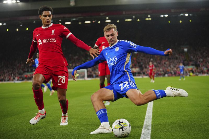 Leicester's Kiernan Dewsbury-Hall, right, passes the ball in front of Liverpool's Jarell Quansah during the English League Cup third round soccer match between Liverpool and Leicester City at the Anfield stadium in Liverpool, England, Wednesday, Sept. 27, 2023. (AP Photo/Jon Super)