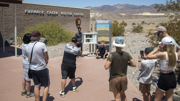 Tourists return photos successful beforehand of nan Furnace Creek visitant halfway thermometer Monday, July 8, 2024, successful Death Valley National Park, Calif.  (Daniel Jacobi II/Las Vegas Review-Journal via AP)