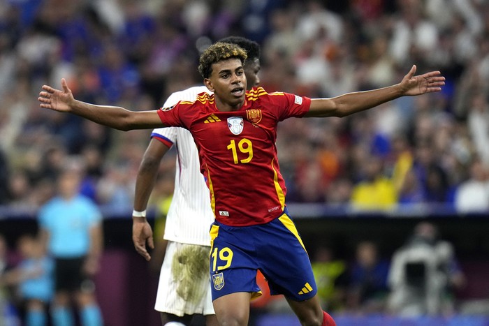 Spains Lamine Yamal reacts during a semifinal match between Spain and France at the Euro 2024 soccer tournament in Munich, Germany, Tuesday, July 9, 2024. Left Spains Rodri. (AP Photo/Hassan Ammar)