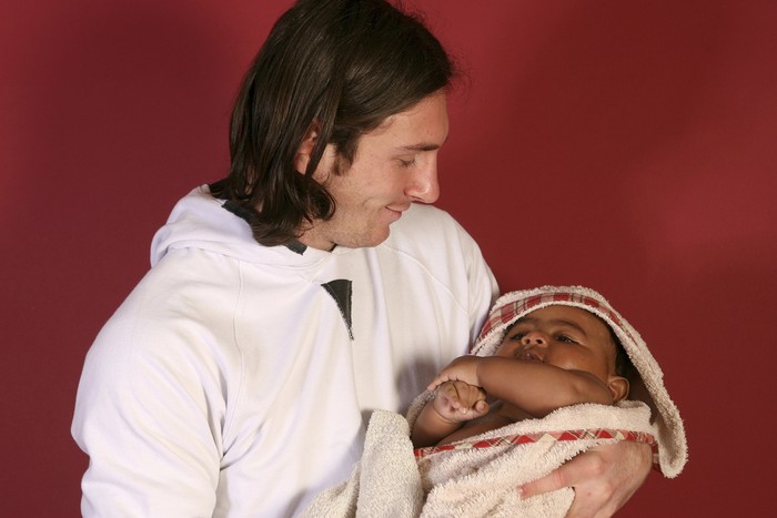 This photo taken in Sept. 2007 shows a 20-year-old Lionel Messi, who had embarked on his legendary Barcelona career just over four years prior, cradling Lamine Yamal, who was merely six months old at the time during a photo session in the dressing room of the Camp Nou stadium in Barcelona, Spain. Lamine Yamal is now a soccer sensation for both Spain and Barcelona and he is still only 16-years-old. (AP Photo/Joan Monfort)