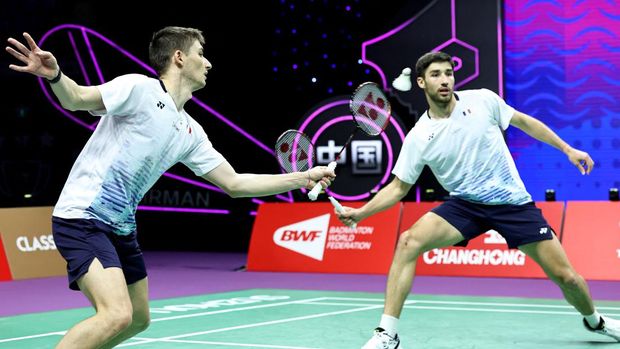 Christo Popov (L) of France hits a return beside partner Toma Junior Popov during their men's doubles match against Takuro Hoki and Yugo Kobayashi of Japan at the Sudirman Cup Finals 2023 world badminton championships in Suzhou, in China's eastern Jiangsu province on May 15, 2023. (Photo by AFP) / China OUT