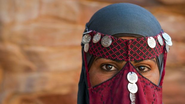 A 24-year-old Bedouin woman outdoors in Petra, Jordan, wearing a traditional veil