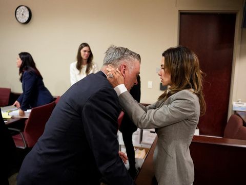 US actor Alec Baldwin and his wife Hilaria Baldwin embrace during his trial on involuntary manslaughter at Santa Fe County District Court in Santa Fe, New Mexico, on July 12, 2024. Baldwin's trial for involuntary manslaughter was dismissed by a judge Friday after she ruled that key evidence over a fatal shooting on the set of 