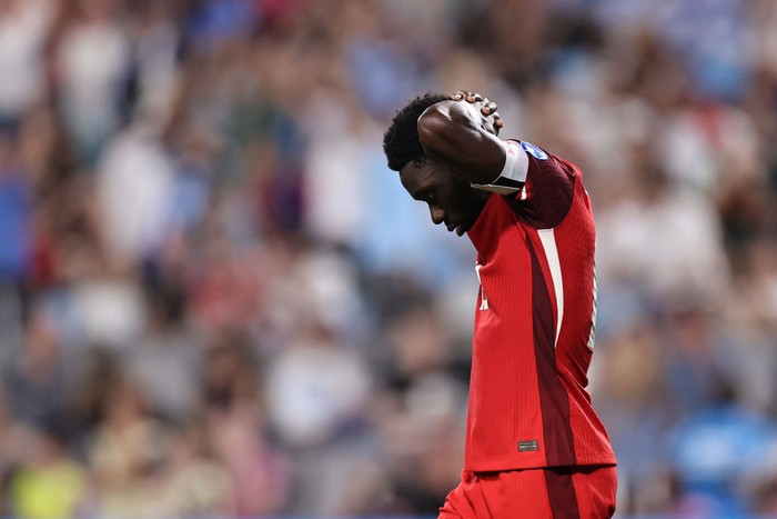CHARLOTTE, NORTH CAROLINA - JULY 13: Alphonso Davies of Canada reacts missing the teams fifth penalty in the penalty shoot out during the CONMEBOL Copa America 2024 third place match between Uruguay and Canada at Bank of America Stadium on July 13, 2024 in Charlotte, North Carolina. (Photo by Omar Vega/Getty Images)