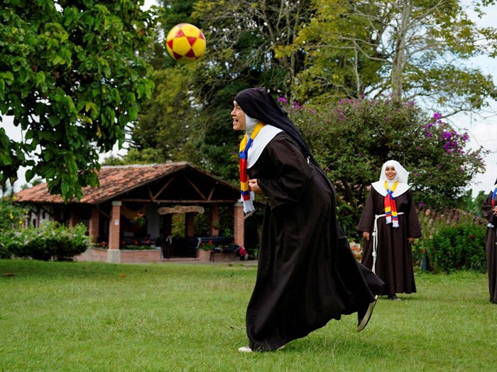 Poor Clare Sisters unfold a flag during a prayer as they support the Colombian national team in the Copa America final against Argentina, at a convent in Montenegro, Colombia  July 13, 2024. REUTERS/Vladimir Encina