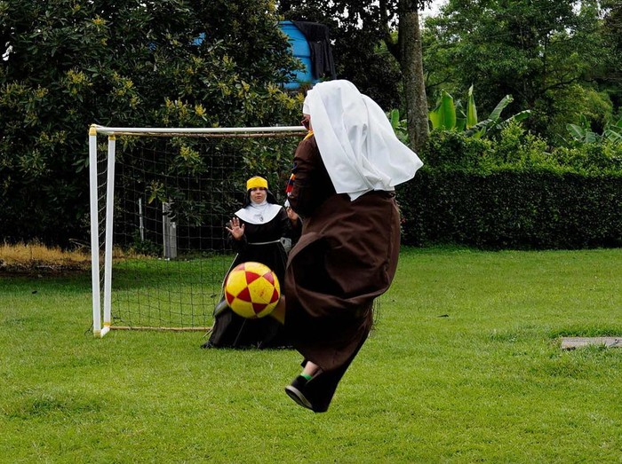 Poor Clare Sisters unfold a flag during a prayer as they support the Colombian national team in the Copa America final against Argentina, at a convent in Montenegro, Colombia  July 13, 2024. REUTERS/Vladimir Encina