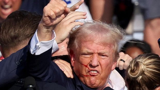 Republican presidential candidate and former U.S. President Donald Trump is assisted by the Secret Service after gunfire rang out during a campaign rally at the Butler Farm Show in Butler, Pennsylvania, U.S., July 13, 2024. REUTERS/Brendan McDermid