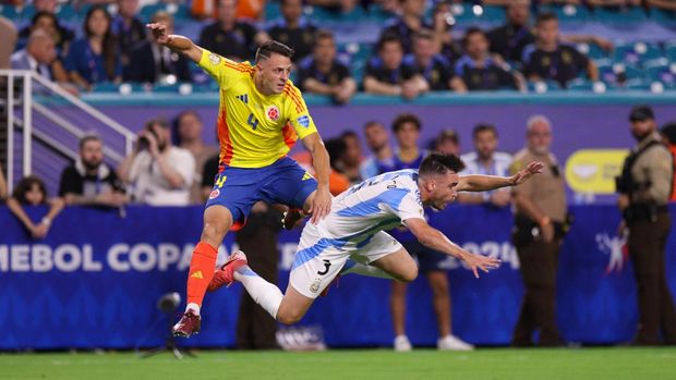 Jul 14, 2024; Miami, FL, USA;  Argentina defender Nicolas Tagliafico (3) and Colombia midfileder Santiago Arias (4) collide in the first half during the Copa America Final at Hard Rock Stadium. Mandatory Credit: Nathan Ray Seebeck-USA TODAY Sports